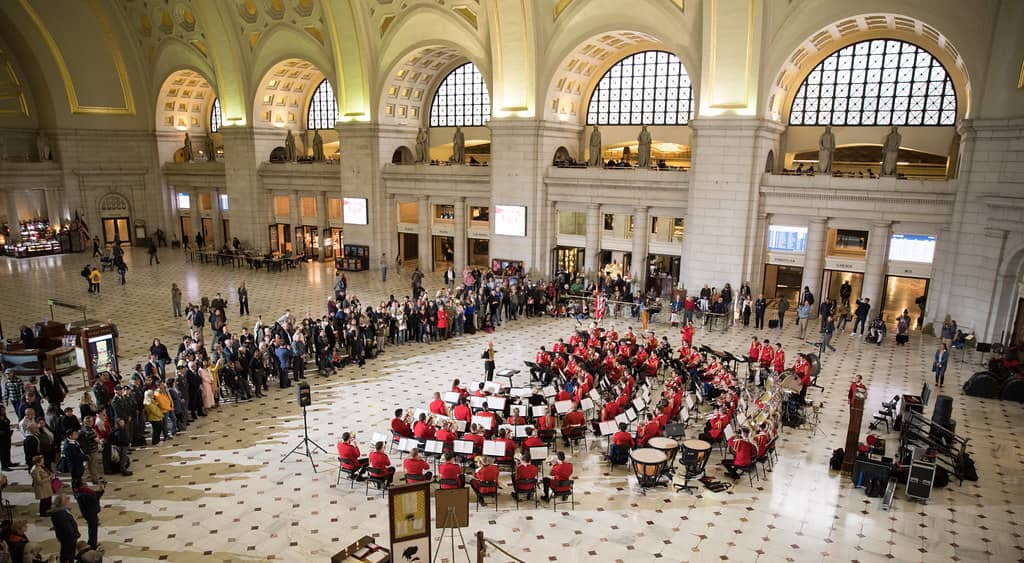 The Swiss Army Central Band, a famous military band, performing in precise formation, dressed in traditional military uniforms with brass instruments, during a ceremonial event that highlights their storied history and musical excellence.