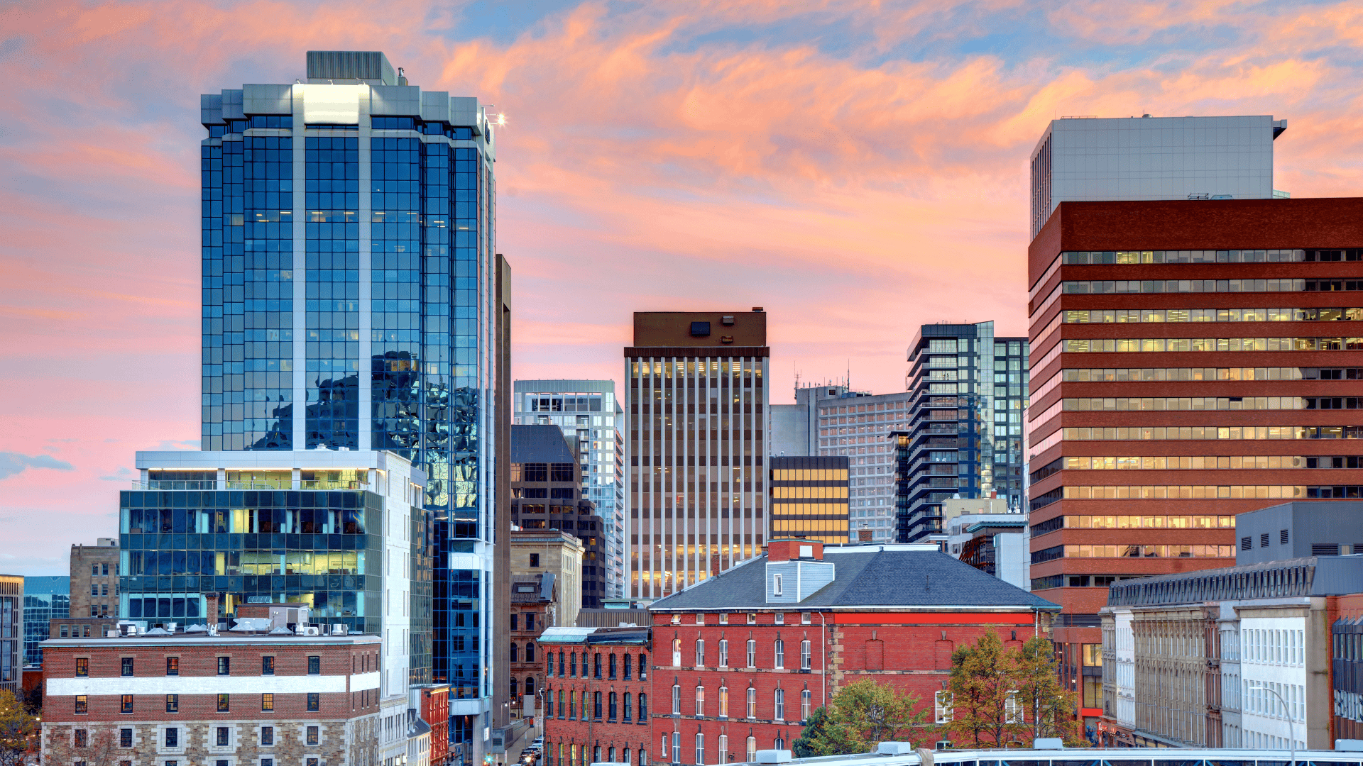 Cityscape of Halifax, Nova Scotia, with modern high-rise buildings and historic architecture at sunset. Suitable accommodations for visitors attending the Royal Nova Scotia International Tattoo.