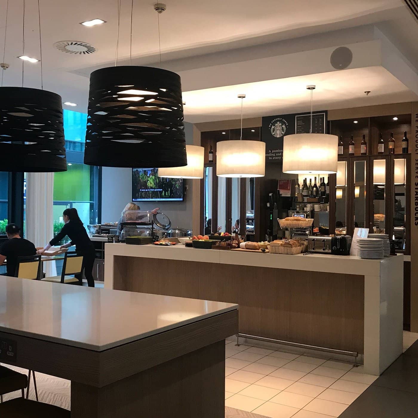 Breakfast area at Residence Inn by Marriott Edinburgh featuring a modern buffet setup with fresh pastries fruits and beverages offering a comfortable dining experience for guests