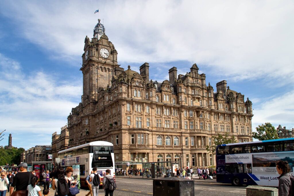 The iconic Balmoral Hotel in Edinburgh, featuring its grand clock tower and stunning Victorian architecture, located in the bustling heart of the city near Waverley Station.