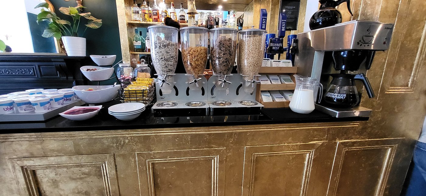 Breakfast bar at The Haymarket Hotel featuring a variety of cereals yogurt fresh fruit and a coffee station providing a convenient and welcoming start to the day for guests