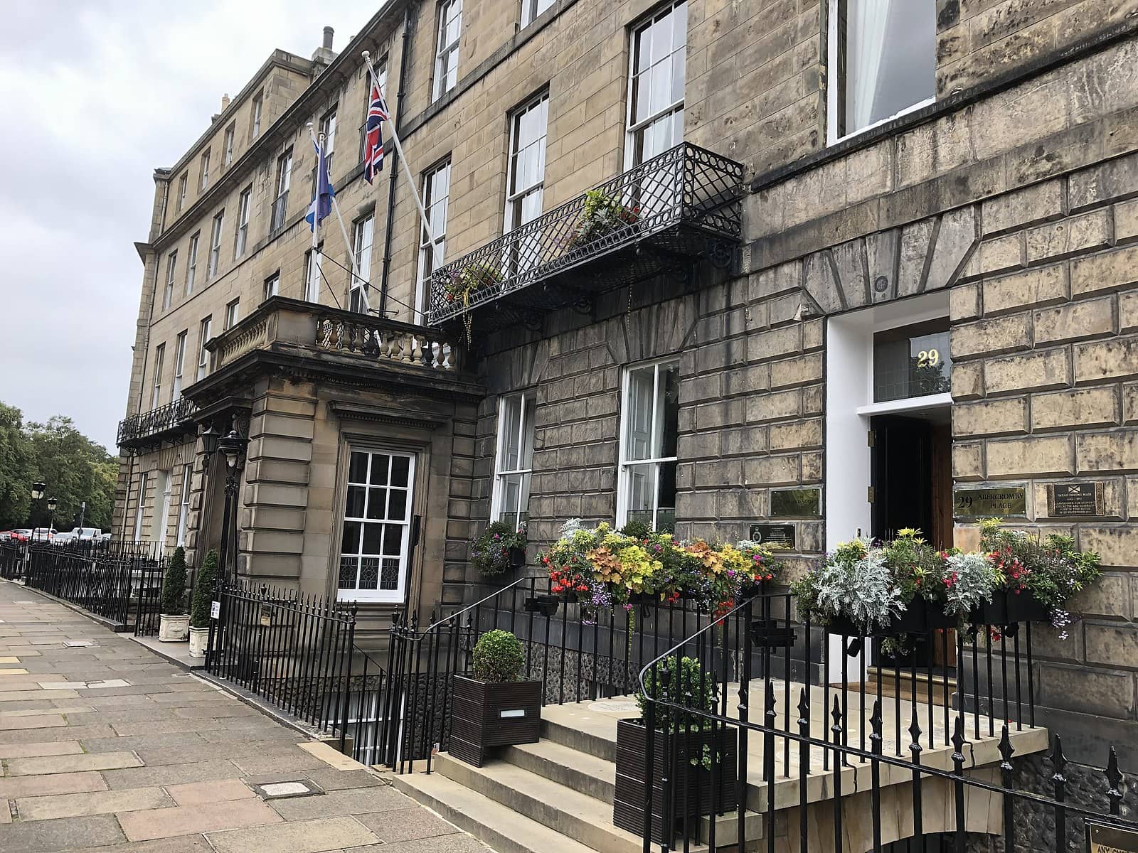 The Royal Scots Club in Edinburgh a classic Georgian building adorned with flags and flower arrangements offering a traditional and elegant stay in the heart of the city