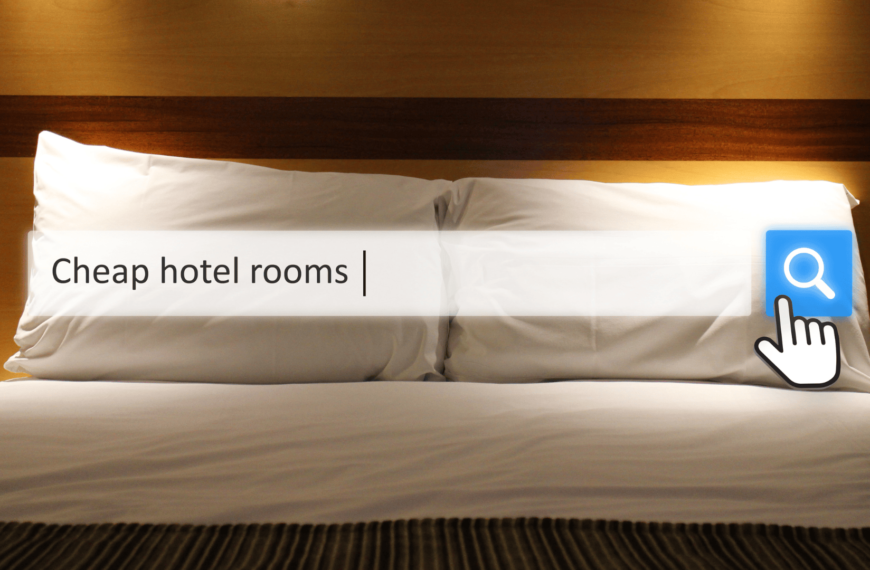 A cozy hotel bed with a search bar overlay displaying the phrase "Cheap hotel rooms," representing a search for affordable accommodations in Edinburgh near Waverley Station.