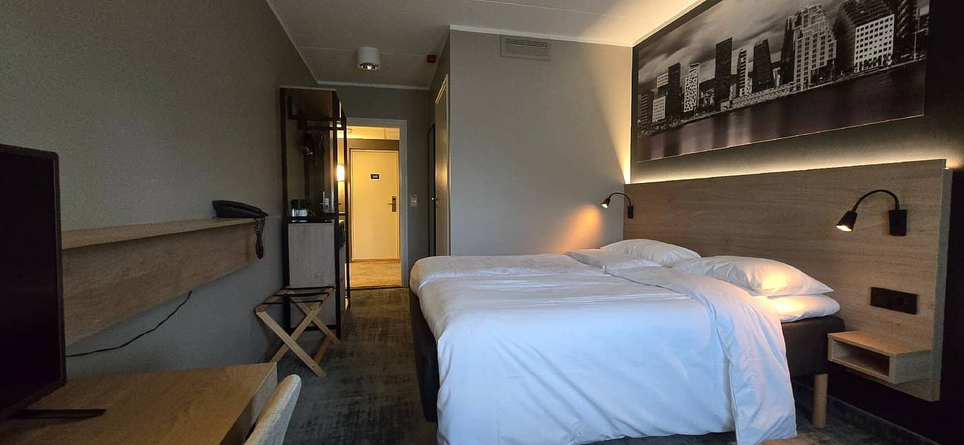 A cozy room at Park Inn by Radisson Oslo Airport Hotel West featuring modern design and convenient amenities for travelers seeking comfort near Oslo Airport