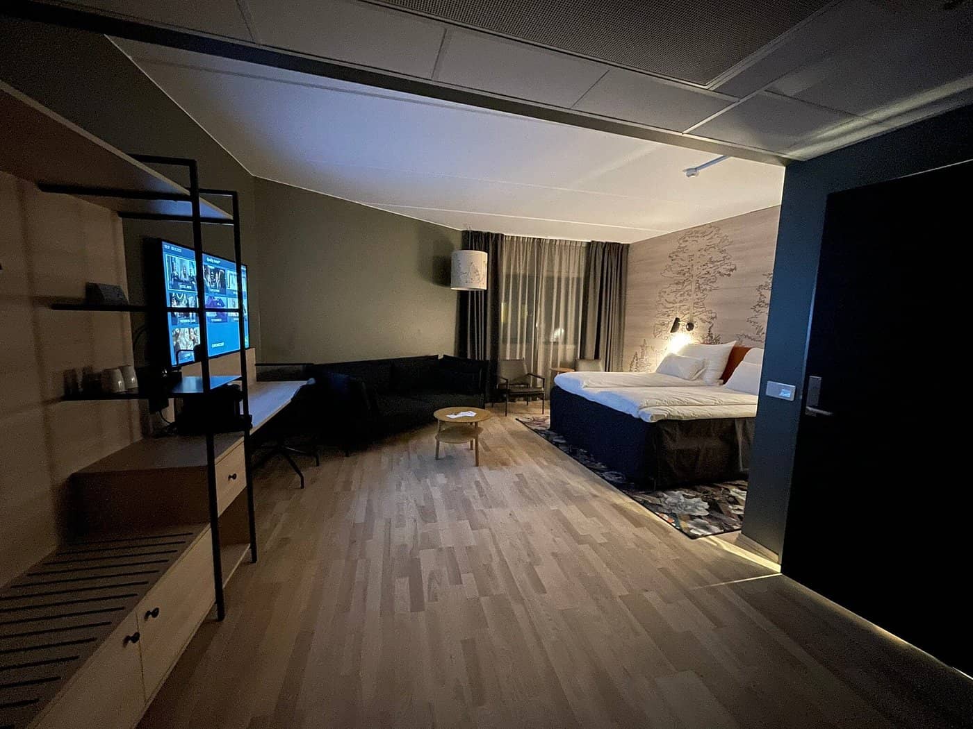 A modern and spacious room at Quality Airport Hotel Gardermoen offering a cozy ambiance with contemporary furnishings warm lighting and a relaxing seating area perfect for a restful stay near Oslo Gardermoen Airport