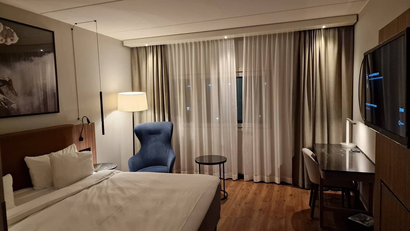 A spacious and elegantly designed room at the Radisson Blu Airport Hotel Oslo Gardermoen offering direct access to the airport terminal Ideal for travelers seeking convenience and comfort