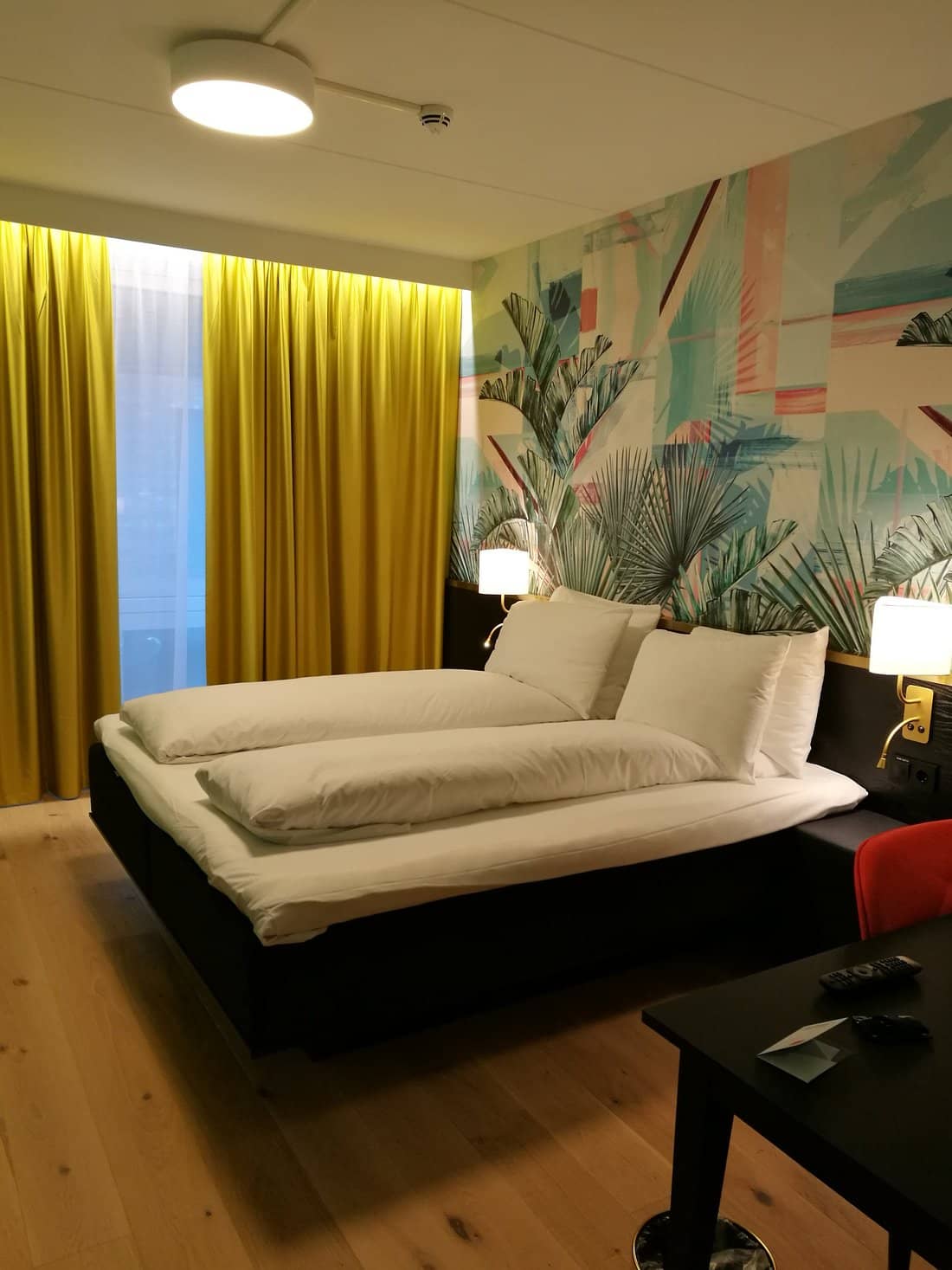 A vibrant room at Thon Hotel Storo featuring colorful decor modern furnishings and a cozy bed offering a stylish and comfortable retreat in Oslo